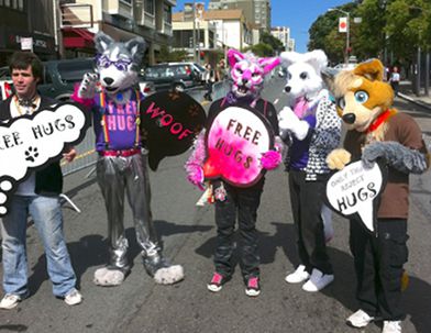 Fursuiters with 'free hugs' signs at GaymerX