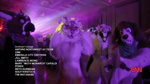 Lisa Ling in a tiger fursuit, dancing with other fursuiters.